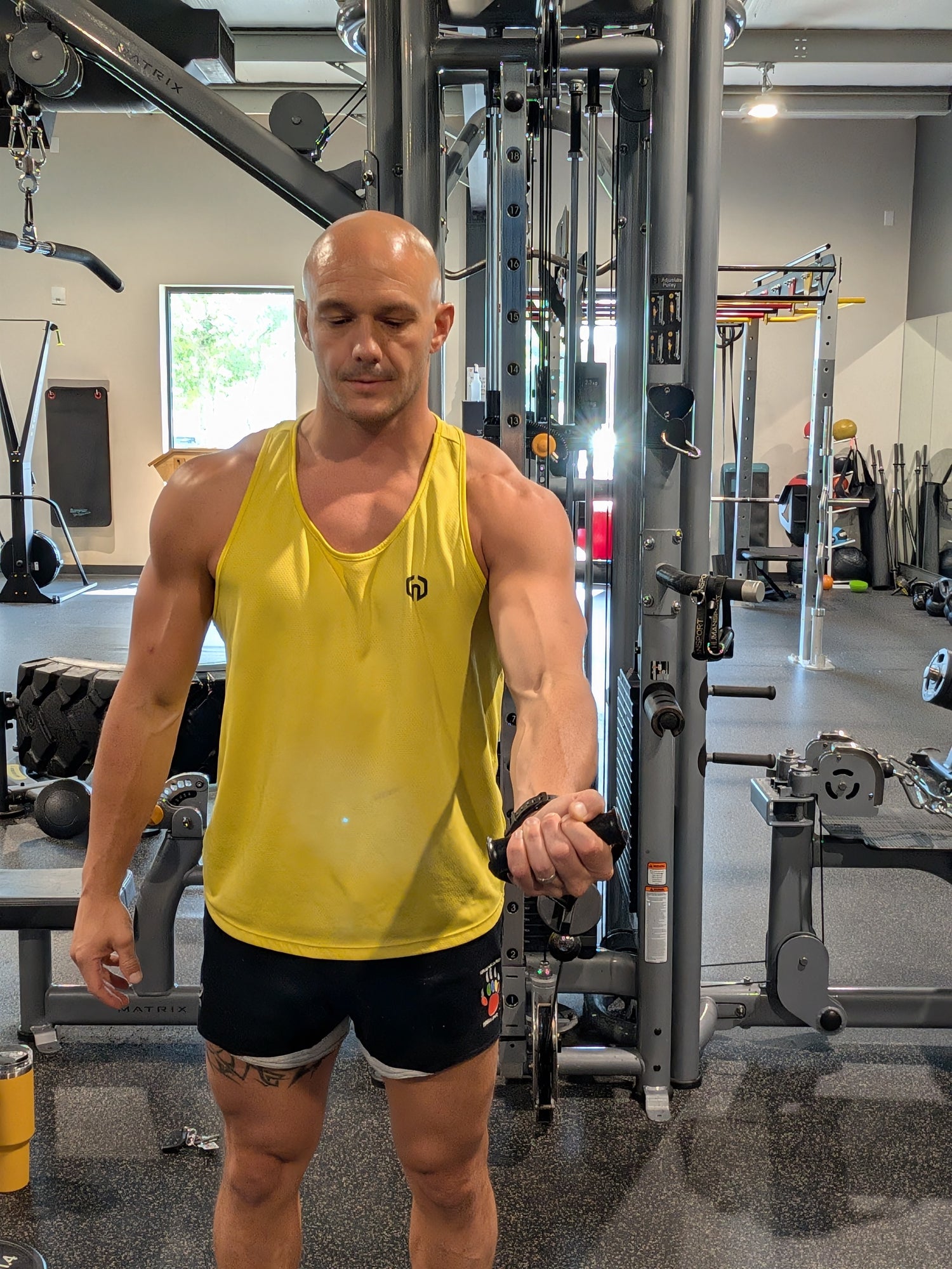 Mathieu Lesgourgues performing cable chest fly exercise in gym