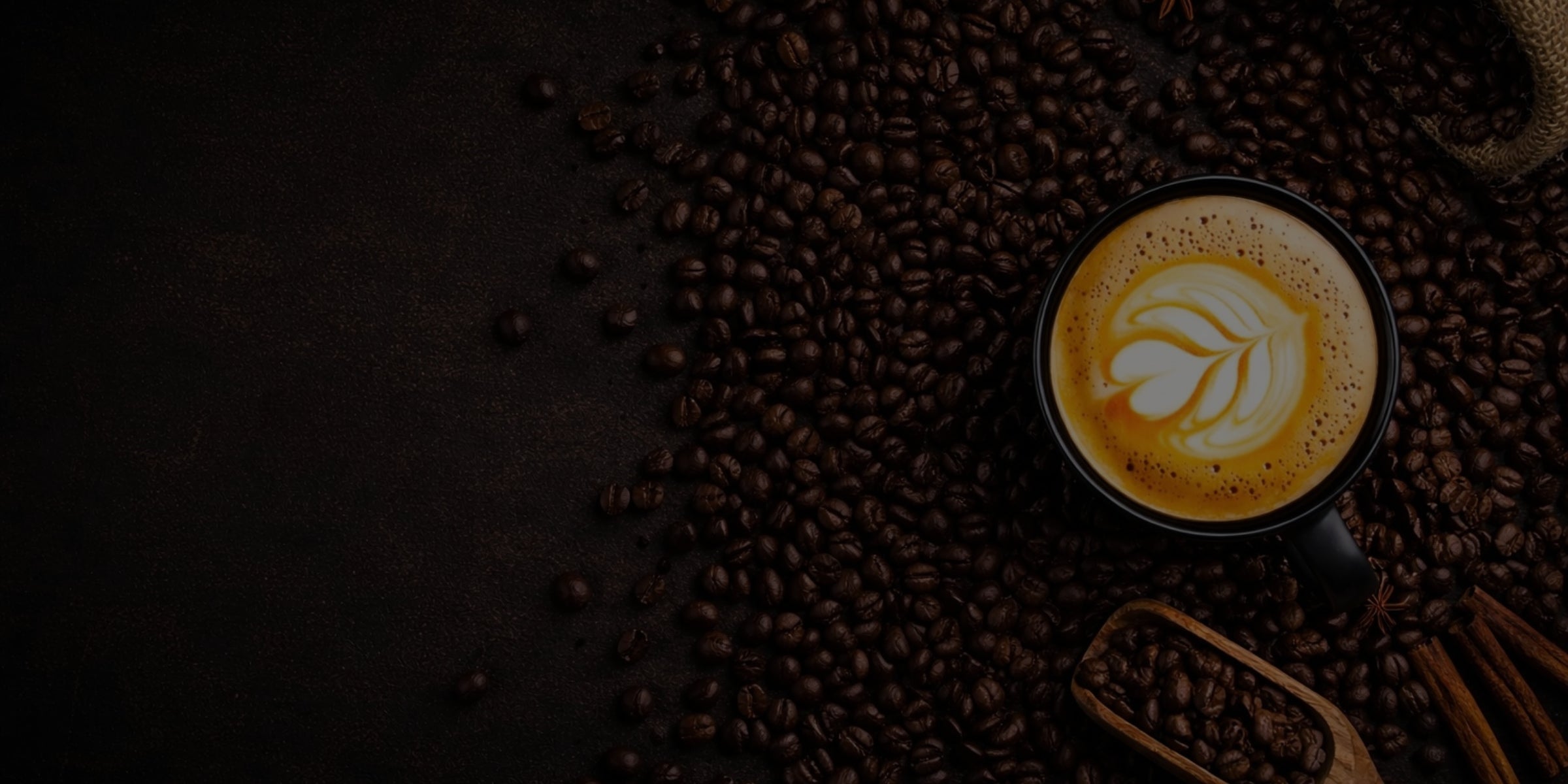 Cup of coffee with latte art on a bed of coffee beans