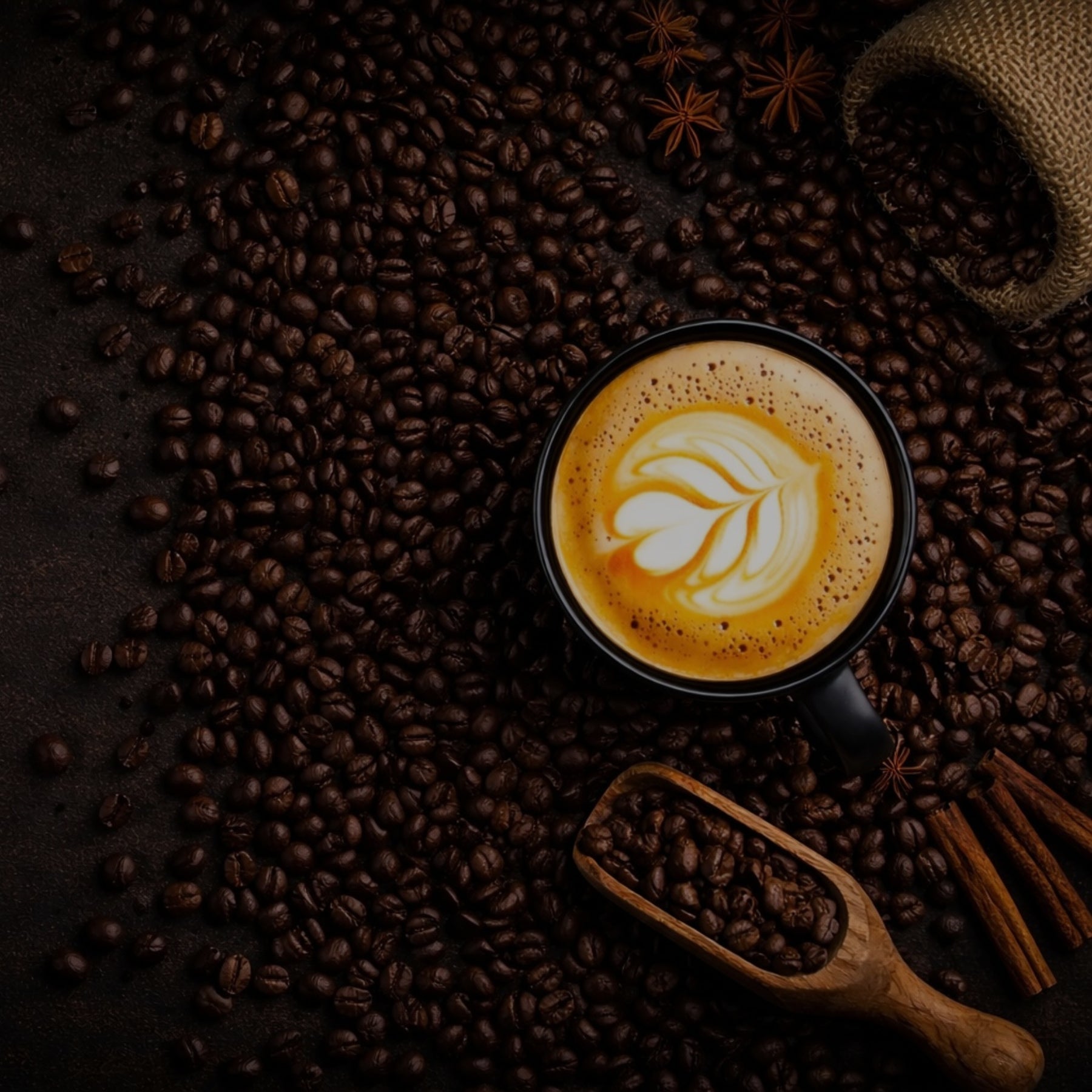Cup of coffee with latte art on a bed of coffee beans