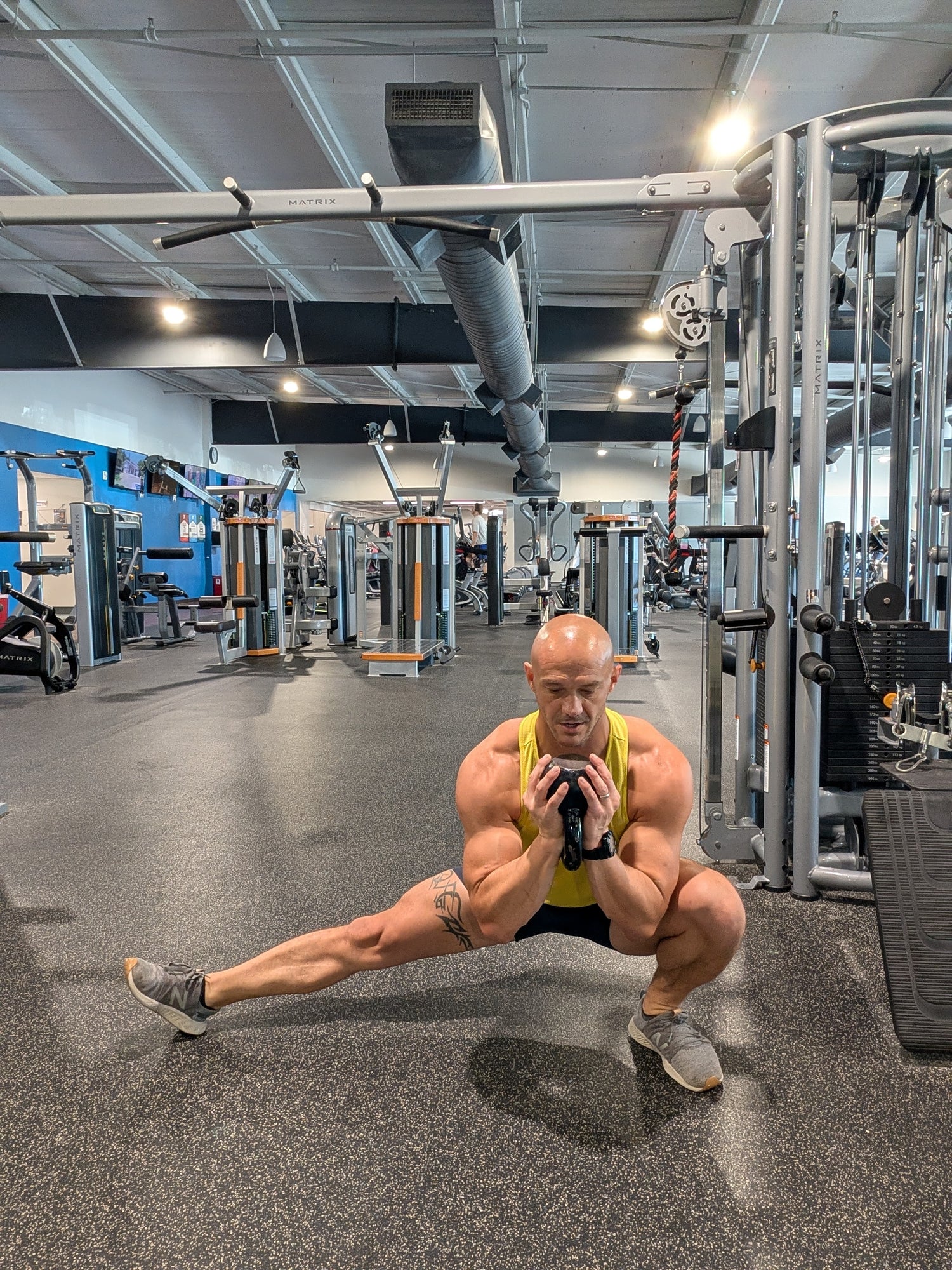 Mathieu Lesgourgues performing goblet cossack squat with kettlebell in gym
